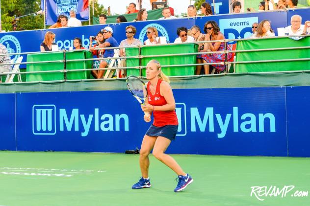 First Lady Michelle Obama looks on as Washington Kastles player Anastasia Rodionova warms-up during yesterday's season opener.